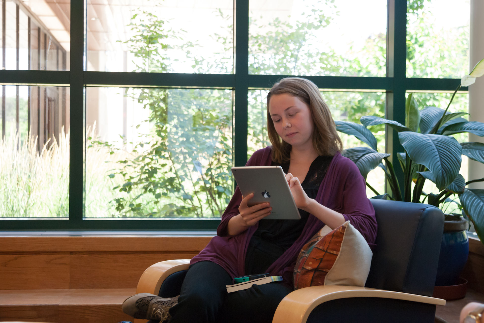 image: student using tablet in lounge 